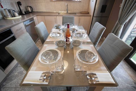 Elegant dining table beautifully set for meals, offering a warm and inviting space to enjoy breakfast or dinner with family and friends.