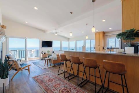 Step into a cozy living room that feels like home, perfect for relaxing or entertaining after a day at the beach.