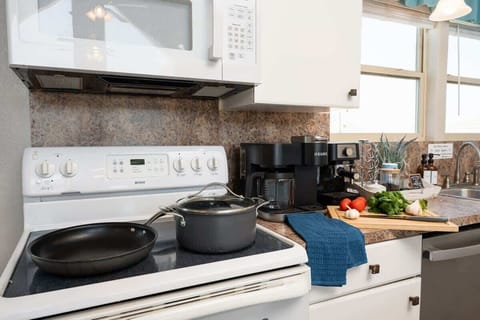 Enjoy the convenience of a fully equipped kitchen featuring a modern stove top and all the essential cookware for easy meal prep
