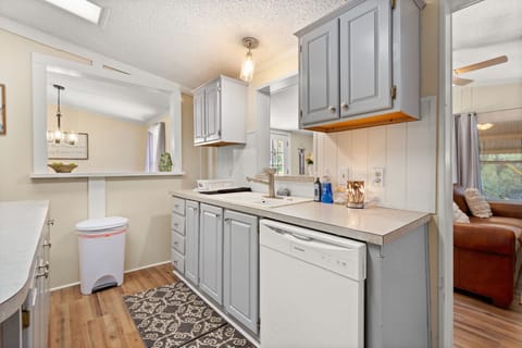 This open kitchen feels spacious and connected, thanks to a large pass-through window and functional layout that supports long-term living.