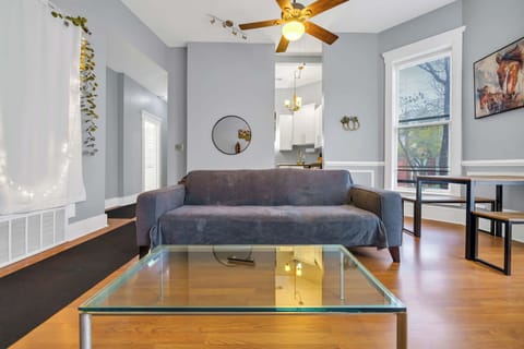 Enjoy the best of modern comfort in this open living area, where a cozy sofa and charming decor create a welcoming atmosphere.