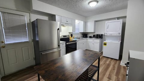 Kitchen: A simple dining set for 4 is perfectly positioned for meals and gatherings.