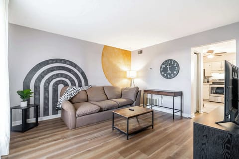 Living Room: Welcome to our spacious living room with a cozy sofa, perfect for you to relax. 