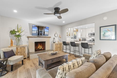 Cozy living space with fireplace and large Smart TV — the perfect place to unwind after the beach.