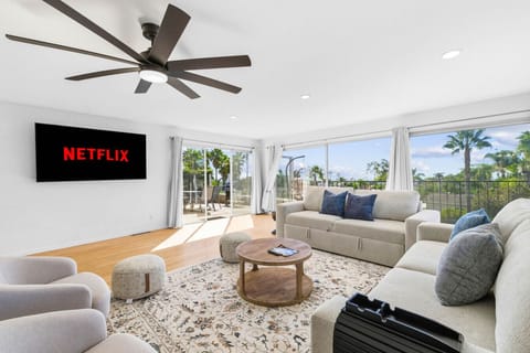 Wind down after a day at the beach with a movie on the large wall-mounted Smart TV (featuring Netflix and other streaming apps).