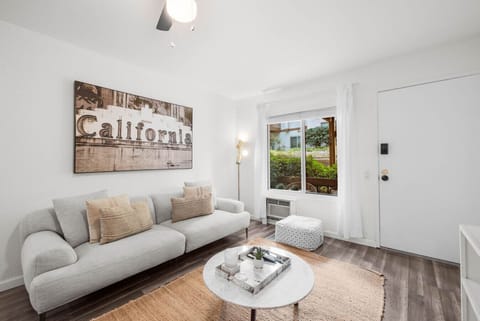 Relax in the stylish living room featuring a comfy sofa, flat-screen TV, and warm California charm.