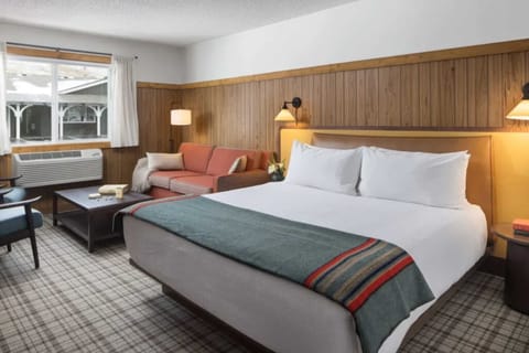 Stretch out on plush bedding with a relaxed lounge corner.