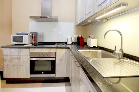 Modern open kitchen is fully fitted with all the appliances