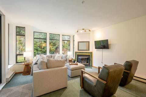 Relax in the family-friendly living room. Thoughtfully designed with warm lighting, neutral tones, and a spacious layout perfect for slow mornings, movie nights, and reconnecting after a day of adventure.