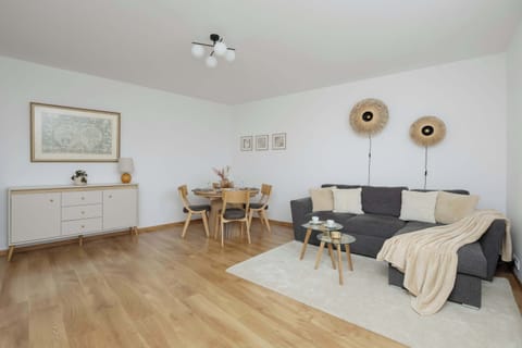 Bright and spacious living room with a cozy seating area, perfect for relaxing after a day in the city.