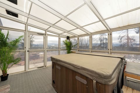 Unwind in your private hot tub sanctuary, surrounded by floor-to-ceiling windows and breathtaking mountain views for the ultimate relaxation escape.
