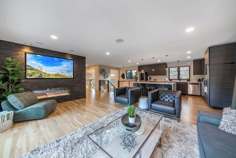 Unwind in your stylish open-concept retreat with soaring ceilings, cozy fireplace, and modern kitchen perfect for entertaining.