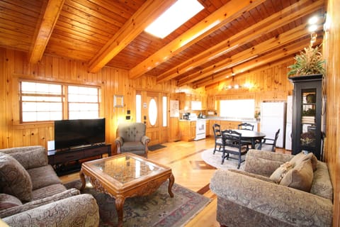 UPPER SUITE: Vaulted ceilings with skylights span the living room and kitchen, creating a bright, open space filled with natural light - perfect for relaxing and enjoying time together