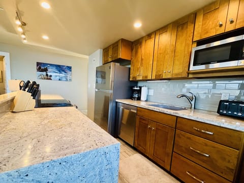 Kitchen fully applianced with stainless steel appliances.