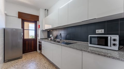 Sleek and fully equipped kitchen with modern appliances and balcony access—perfect for cooking with a view.
#FaroApartment #ModernKitchen #HolidayRental #AlgarveStay #SelfCatering