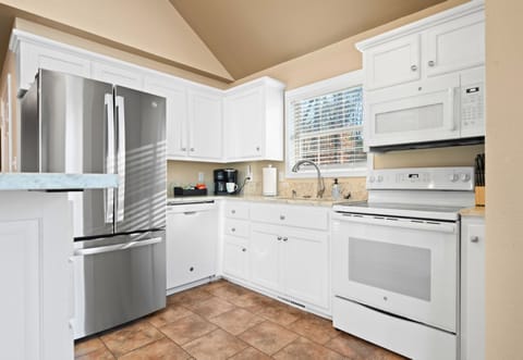 Bright cabinetry and updated appliances make it easy to prepare meals or snacks whenever hunger strikes.