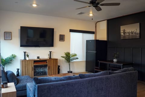 Open living-dining area with fridge, bright, comfy, and great for gathering.