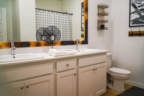 Elegant his and hers bathroom with a shower and a tub.
