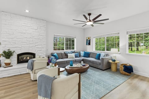 Cozy living room with fireplace and plenty of natural light, quiet and peaceful. Ceiling fan for airflow. 