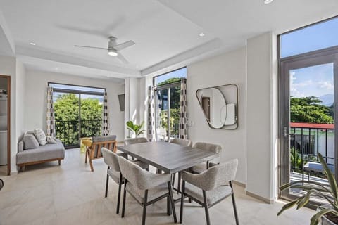 Gather for meals at this contemporary dining table with seating for six. Large sliding glass doors bathe the room in natural light and bring the beautiful outdoors inside.