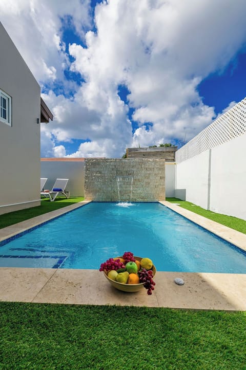 Escape to your own private oasis! Dive into the sparkling blue, soak up the sun on the turf, and let the waterfall feature wash your worries away.