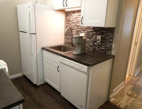 This is the right half of the kitchen.  You can see the dishwasher and refrigerator, both less than three years old.  The cupboard to the top right is where we leave some treats for you to enjoy.