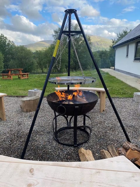 Fire pit area with bench seating for 8. For BBQs and outdoor log fires.