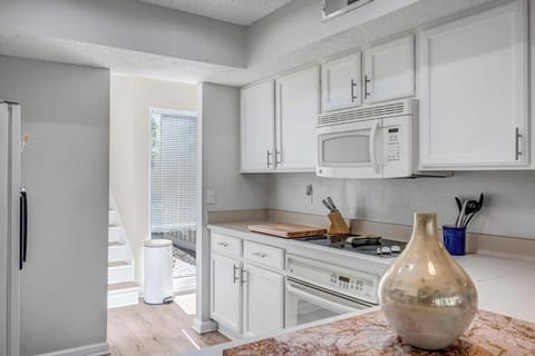 Bright kitchen w/ white cabinetry, warm wood counters, and a clean layout that makes cooking feel easy.