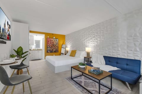 3D Panel with Yellow - Bedroom with yellow wall, white bed, and blue sofa