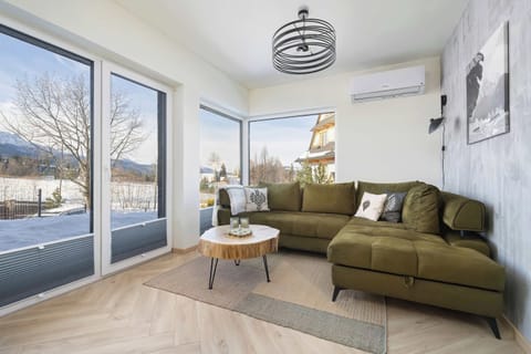 Relax in the stylish living room with a comfortable sofa and modern decor.