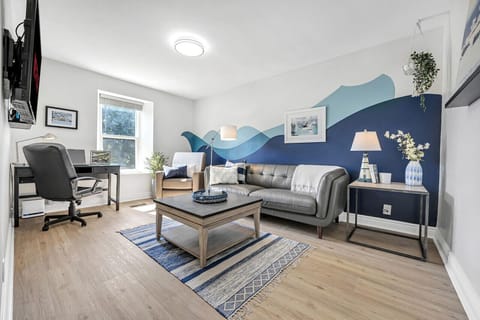 Comfy living room with a smart TV with streaming services, and a large collection of games and books!