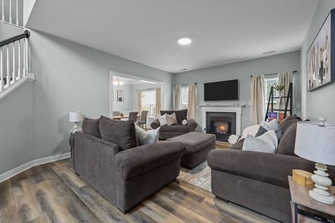 Spacious living area with fireplace and smart TV — perfect for large groups