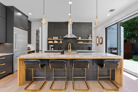 Bright, fully equipped kitchen featuring a roomy island for cooking and conversation.