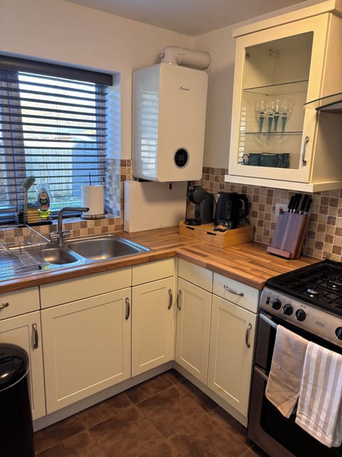 The kitchen has a coffee machine and some biscuits for you