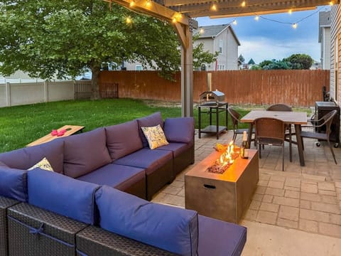 Your private backyard oasis — fire table, woodfire pizza oven, seating, and space for the whole family.