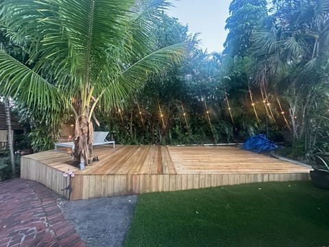 Illuminated backyard deck perfect for evening gatherings and outdoor lounging.