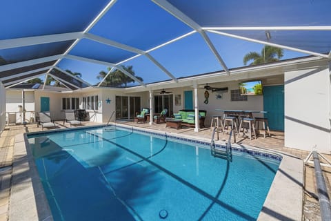 Private screened-in pool and lanai with outdoor seating.
