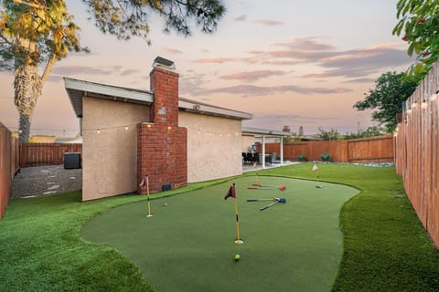 Fun backyard space featuring a mini golf setup for all ages.