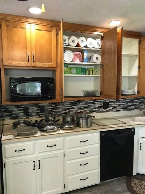 Kitchen showing some of available dishes, utensils and appliances
