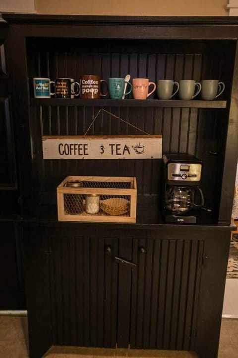 Coffee and Tea nook with mugs, coffee maker, and supplies
