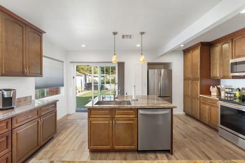 Large island and farm sink with a great view to the backyard.