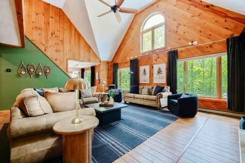 Vaulted ceilings • Natural light • Sunrise view through the trees