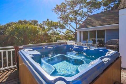 The roof deck features a hot tub, outoor dining table & chairs and a gas BBQ grill.