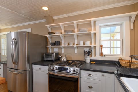 Your fully equipped kitchen features stainless steel appliances, open shelving for dishes, and all the essentials you need to prepare meals during your stay.