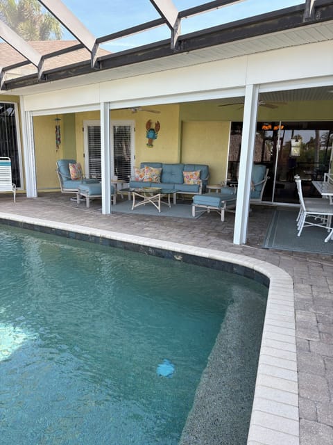 Lanai next to pool and hot tub, ideal for relaxing and enjoying the outdoors. 