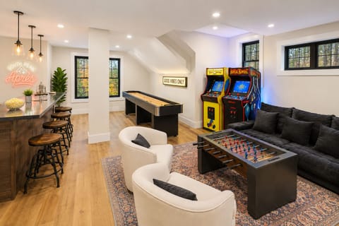 Private game room with arcade games, foosball, shuffleboard & bar