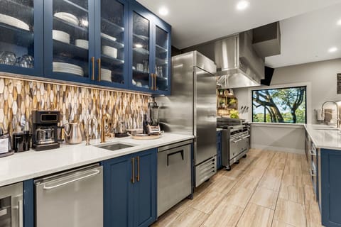 Chef’s kitchen featuring premium appliances, and expansive counter space