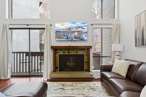 Warm, welcoming living room with fireplace for peaceful evenings in.A comfy spot to unwind, play games, and enjoy time together.
