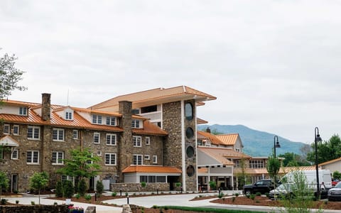 Stone building with circular windows and copper roofing