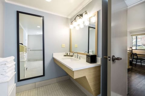 Bathroom with large mirror and bright lighting